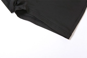 Close-up of black backless jumpsuit featuring precise double-needle hem stitching detail