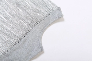 Detailed view of grey knit fabric featuring long fringe tassels for a trendy street look