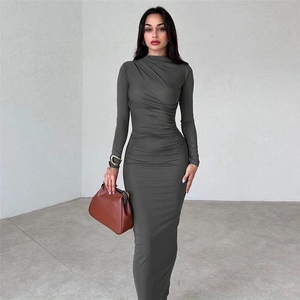 Detailed texture of charcoal grey long sleeve bodycon dress with ruched fabric details