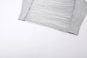 Close-up of gray sleeveless top with intricate horizontal fringe and hollow-out details