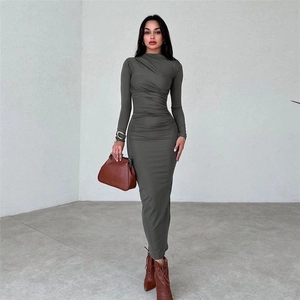 Detailed close-up of dark grey-green ruched bodycon dress with elegant pleats and long sleeves