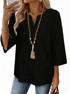 Detail of V-neck lace embroidery and bohemian bead tassel necklace on black tunic top