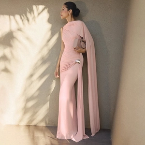Détail d'une robe longue ajustée rose clair avec drapé élégant et boucle de taille argentée