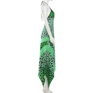 Side view of backless halter maxi dress with green leopard print and handkerchief hem