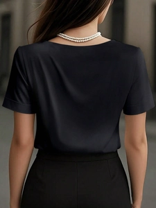 Rear view of sleek black satin short-sleeved top with premium draping fabric