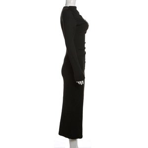 Detail view of the side ruching and slim fit texture on this black long sleeve maxi dress