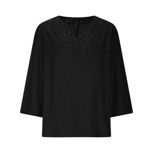 Detailed view of the V-neckline with delicate black lace embroidery on the black tunic top