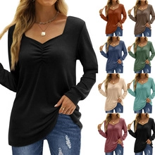 Detail view of slim fit V-neck long sleeve tops showing multiple colors and ruched front