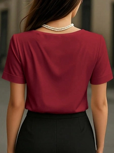 Detail view of red V-neck satin top featuring soft texture and elegant back draping