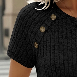 Detail of black ribbed knit short sleeve top featuring brown buttons on shoulder