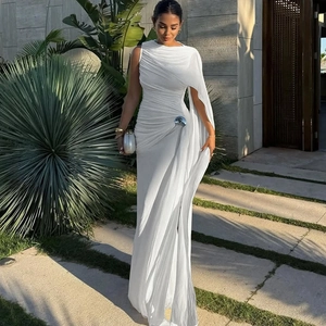 Détail de robe drapée blanche avec boucle argentée et manches cape élégantes