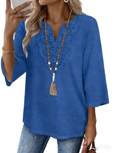 Detail of V-neck lace embroidery and textured fabric on a casual blue women's top