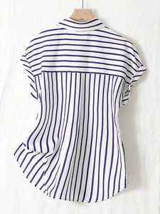 Detailed view of the striped short sleeve shirt with unique vertical and horizontal patterns