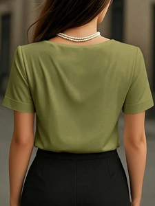Rear view of an olive green satin V-neck T-shirt with smooth texture and urban background