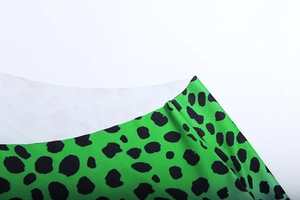 Close-up of the green leopard print fabric texture and neckline stitching detail
