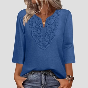 Detailed close-up of V-neckline with intricate lace embroidery on a blue women top