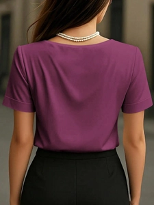 Back view of elegant magenta satin short sleeve top with a silky texture and rolled sleeves