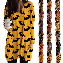 Detail of Halloween V-neck dress with pockets featuring orange bat and polka dot patterns