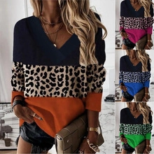 Close-up of leopard print patchwork and vibrant color-block panels on V-neck tunic top