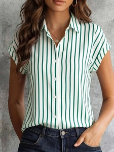 Detailed close-up of dark green vertical striped shirt with white buttons and lapel