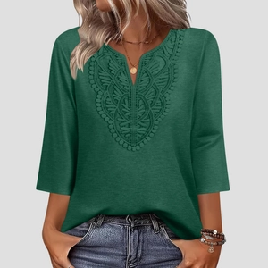 Detail of V-neck lace crochet trim on a dark green bohemian three-quarter sleeve top