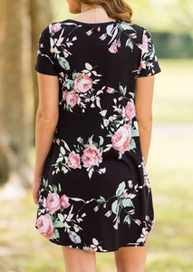 Detailed back view of a black floral dress featuring pink rose prints and short sleeves