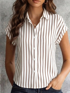 Detail of vertical brown stripes and white buttons on a short sleeve shirt