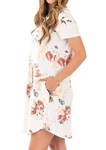 Detail of white summer dress with red floral print and functional side pockets