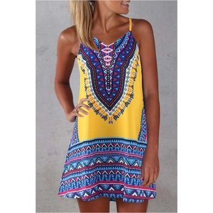 Detail of bohemian geometric patterns on bright yellow summer sundress with vibrant print