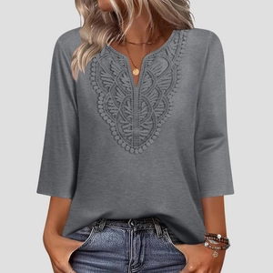 Detailed view of the V-neck lace embroidery on a gray three-quarter sleeve top for women
