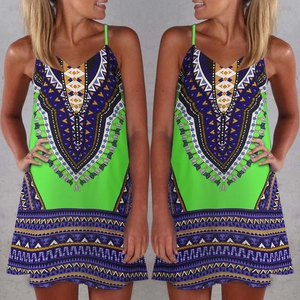 Detailed close-up of vibrant neon green summer dress with ethnic geometric print patterns