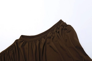 Vue détaillée de l'encolure plissée et de la texture soyeuse du tissu marron foncé