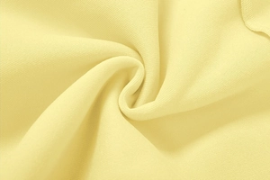 Makroaufnahme der hellgelben Baumwoll-Stricktextur für Damen-Freizeitanzüge