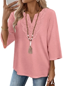 Detail of delicate lace embroidery on V-neck pink blouse with three-quarter sleeves