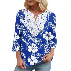 Dettaglio dello scollo a V con pizzo bianco su top blu con stampa floreale tropicale