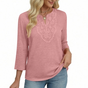 Detailed close-up of V-neck lace embroidery and slub texture on dusty pink t-shirt