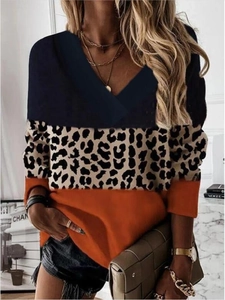 Detail of V-neck top with leopard print and caramel color blocking on long sleeves