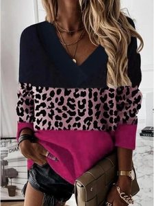 Detail of the V-neck and pink leopard print pattern on this long sleeve women's top