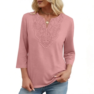 Close-up of elegant V-neckline with lace embroidery on a dusty rose three-quarter sleeve top
