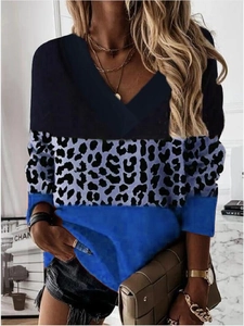 Detail of V-neck stitching with leopard print and royal blue paneling on a long sleeve top