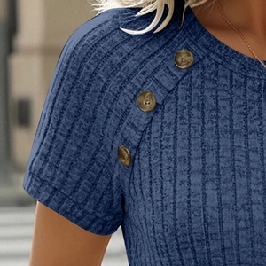 Detail view of the blue ribbed knit fabric and decorative brown wood-style buttons on shoulder
