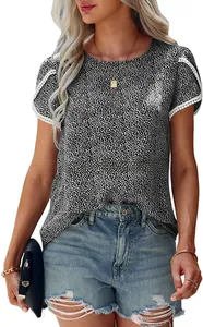 Close-up of elegant lace patchwork detailing on short sleeves of a polka dot t-shirt