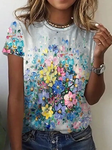 Close-up of colorful oil painting style floral print on light blue-grey summer T-shirt