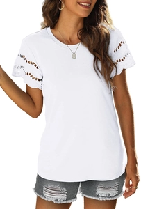 Close-up of intricate white lace embroidery detail on short sleeve cuff of a summer t-shirt