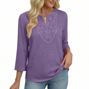 Close-up of intricate lace neckline and V-neck embroidery on purple three-quarter sleeve top