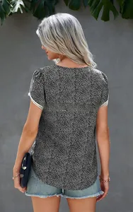 Rear view of lace patchwork short sleeve top with polka dots and frayed denim shorts