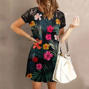 Detail of floral summer dress featuring black lace patchwork sleeves and tropical print