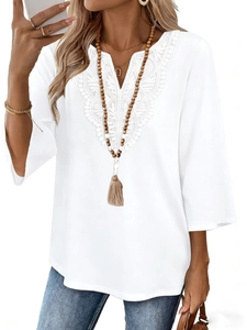 Close-up of elegant V-neck lace detailing on white loose fit three-quarter sleeve top