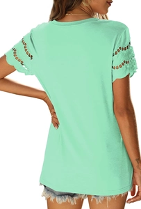 Detail of mint green t-shirt featuring intricate hollow-out lace sleeves and round neck