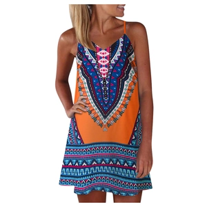 Close-up of bohemian tribal pattern print on orange summer strap dress with V-neckline